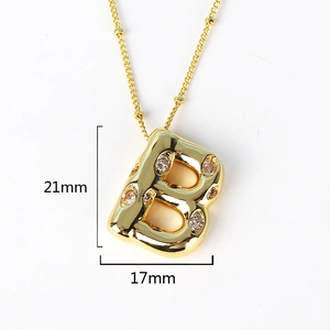 Macro detail of gold-plated iced-out letter B pendant with dimensions 21mm by 17mm