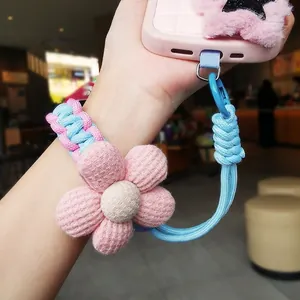 Braided flower phone wrist strap in pink and blue with adjustable buckle and lobster clasp