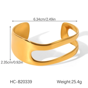 Macro view of gold irregular hollow bangle showing wave design and dimensions