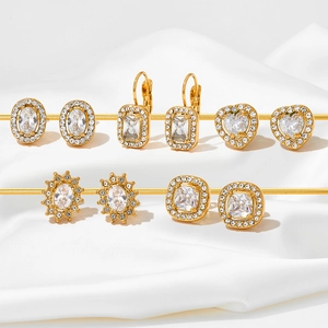 5-pair emerald green and zircon gold earring set displayed on elegant white silk fabric