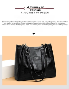 Detail of black pebbled PU leather tote bag with patchwork design and silver metal rings
