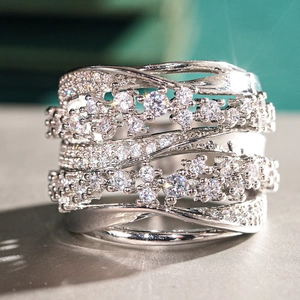 Macro shot of silver-tone multi-layer crisscross ring with pavé set cubic zirconia crystals