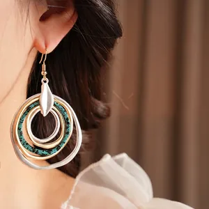 Ethnic bohemian layered circular drop earrings with vintage gold and teal textures