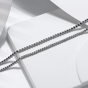 Macro detail of S925 sterling silver tennis chain featuring black round-cut cubic zirconia