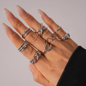 Detail view of 8-piece silver geometric stacking rings set on a model hand