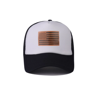 Detail of breathable black mesh and USA flag leather patch on the white trucker hat