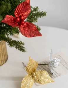 Detail of glittered Christmas berries in red, gold and silver for holiday tree decoration