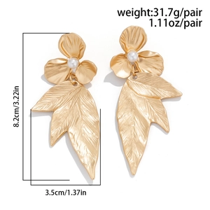 Detailed view of matte gold ginkgo leaf earrings with pearl flower and measurement specs