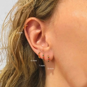 Rainbow cubic zirconia gold hoop earrings shown in 6mm, 7mm, and 8mm sizes on ear