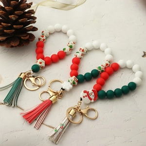 Close-up of Christmas silicone bead bracelets with leather tassels and snowman charms
