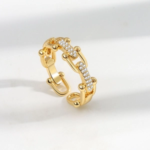 Minimalist gold U-shaped horseshoe chain ring with pavé diamonds on a white background