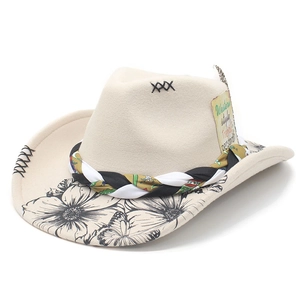 Detail of white felt cowboy hat featuring intricate black floral prints and braided cord
