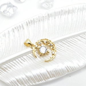 Elegant 18k gold plated star and moon pendant with white zircons on a decorative plate