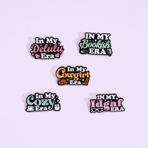 Set of five colorful enamel pins with inspirational 'In My Era' English quotes and slogans