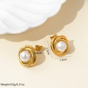 Detailed view of spiral texture gold earrings with pearl showing 1.5cm diameter size