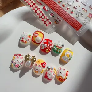 Macro detail of embossed nail art stickers featuring 3D rabbits and festive lucky charms