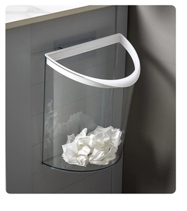 Modern wall-mounted transparent kitchen trash can with white frame on gray cabinet