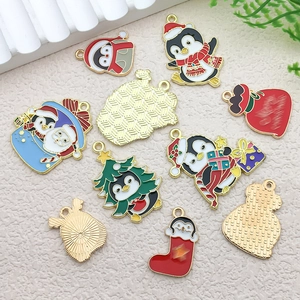 Macro view of Christmas penguin and gift bag alloy charms with glossy enamel finish