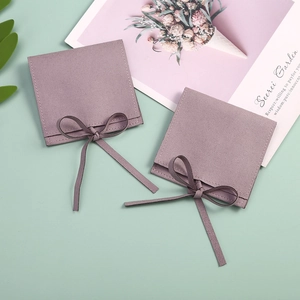 Detailed view of lavender velvet jewelry pouches with elegant ribbon bow closures