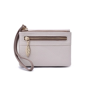 Close-up of beige textured short wallet with double gold zippers and leaf puller detail