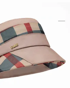 Close-up of wide brim plaid bucket hat with golden brand logo and elegant stitching