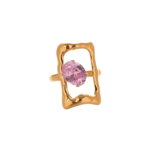 Irregular geometric gold ring with pink oval zircon gemstone on a clean white background