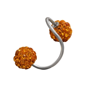 Close-up of curved steel barbell piercing with sparkling orange pavé crystal balls