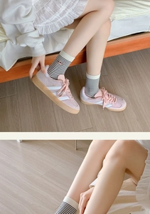 Close-up of pink suede Adidas Gazelle sneakers showing texture and brand details