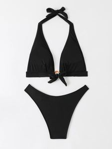 Flat lay of black halter bikini with tortoise ring detail and side bow tie accents