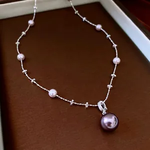 French style pearl necklace with zircon and dark purple pendant on a jewelry display box