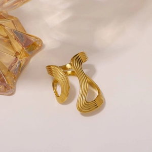 Minimalist 18K gold wave pattern stainless steel open ring shown from a side angle view