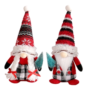 Pair of cute Christmas gnomes with striped hats and tiny trees for holiday home decor