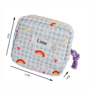Quilted cotton rainbow mini pouch measuring 11x10x4cm with purple knot zipper