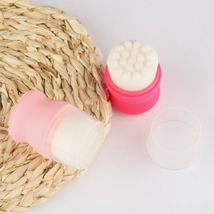 Detailed view of dual-sided facial cleansing brushes with soft nylon bristles and silicone base