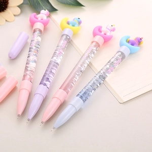 Cute unicorn quicksand gel pens in pastel colors on a desktop for students