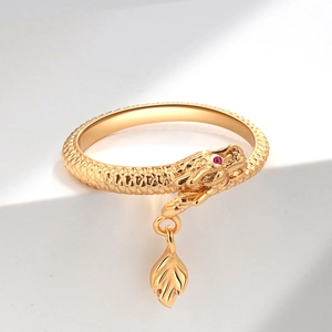 Exquisite golden dragon ring with pink gemstone eyes on minimalist white steps