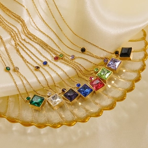 Colorful square crystal necklaces in 14K gold plated stainless steel on luxury display