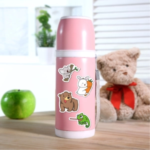 Close-up of cute cartoon stickers on a pink kids water bottle with a woven strap