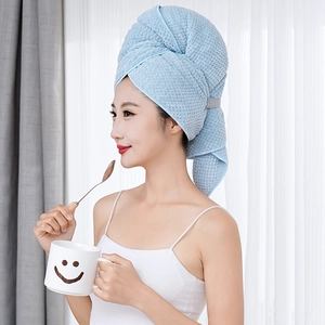Close-up of light blue waffle weave microfiber hair towel for fast water absorption