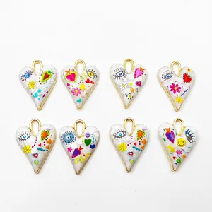 Set of 8 heart-shaped charms with colorful patterns and gold metallic borders