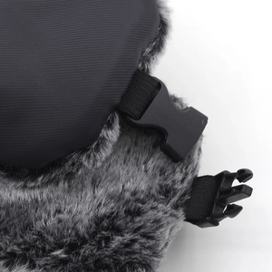 Detail of winter trapper hat showing windproof black fabric and thick grey faux fur lining