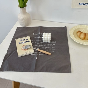 Minimalist dark grey linen placemat with white Scandinavian typography for home dining décor