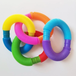 Colorful sensory pop tubes for children in bright yellow, pink, green, and blue hues