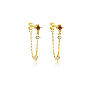 Macro shot of gold S925 silver earrings with brown square zircon and tassel chains