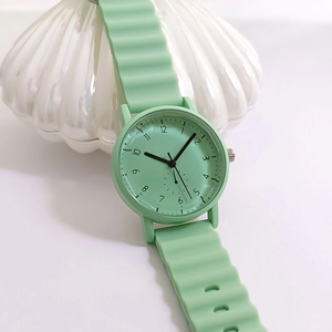 Close-up of mint green quartz watch featuring a unique wavy silicone strap design