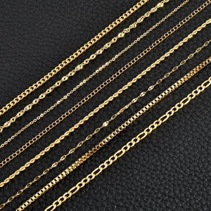 Selection of 18K gold plated stainless steel necklaces on black leather background