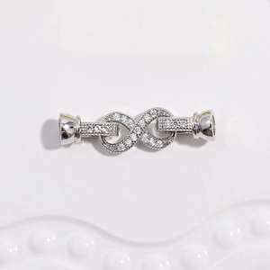 Macro shot of silver infinity clasp with cubic zirconia for jewelry making
