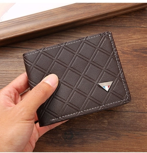 Detail view of men's dark brown bifold wallet with quilted pattern and metal triangle logo