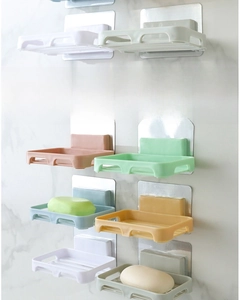Detail of wall-mounted drainage soap dish showing strong adhesive and color variety