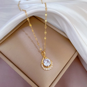 Detailed view of titanium steel teardrop pendant necklace with sparkling pavé diamonds